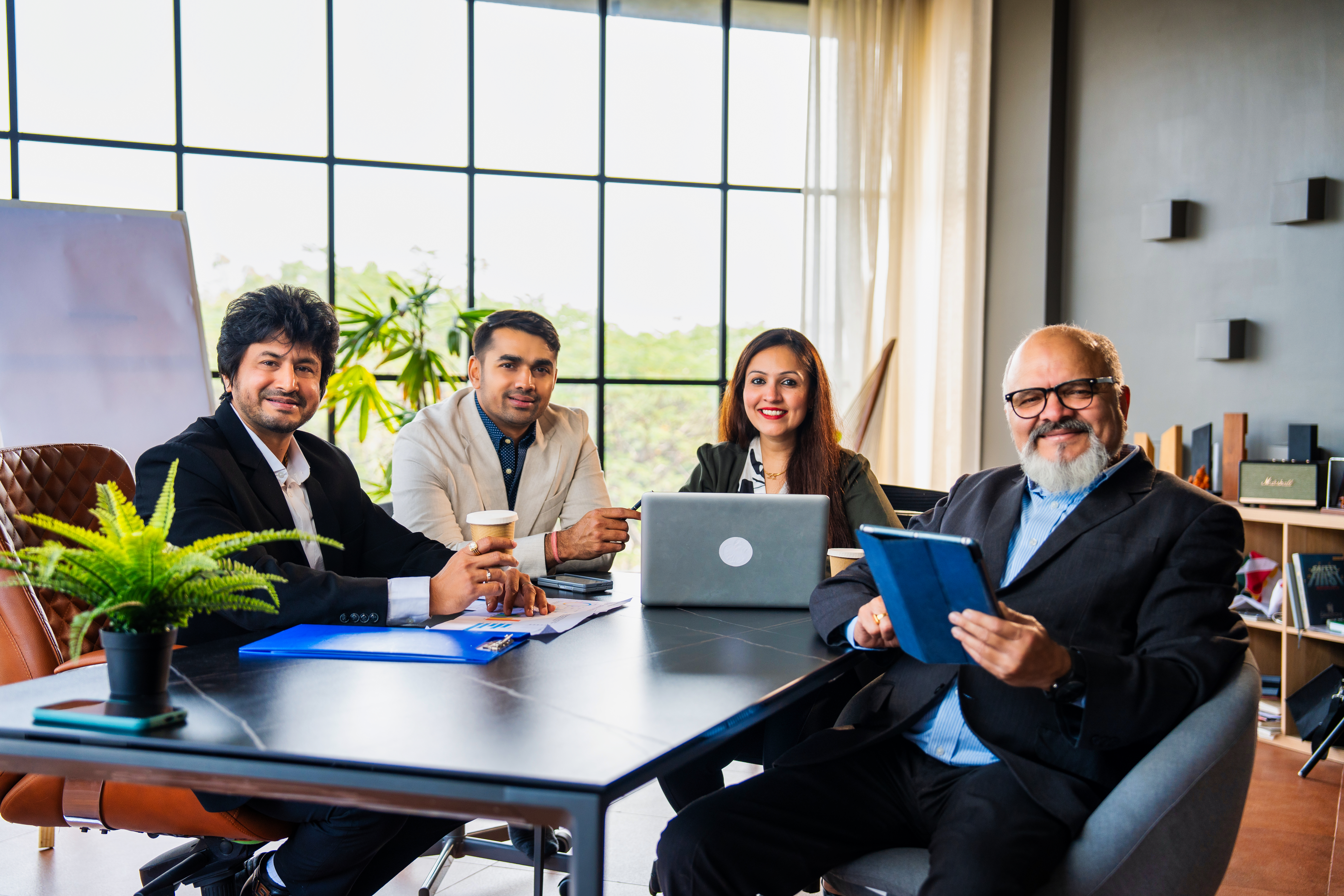 Indian asian Corporate team brainstorming business strategies in a conference room meeting