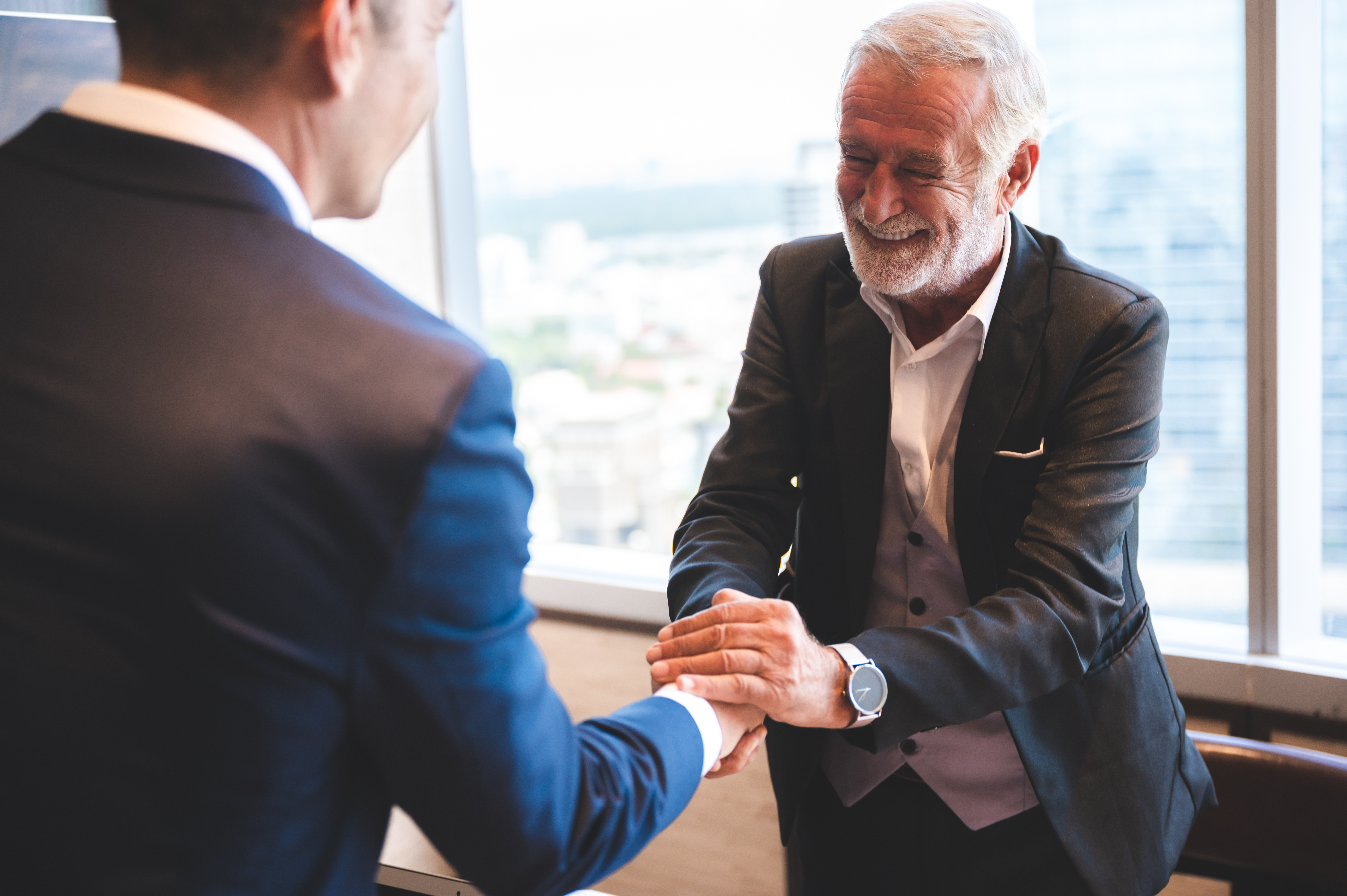 successful negotiate and handshake concept, two businessman shake hand with partner to celebration partnership and teamwork, business deal